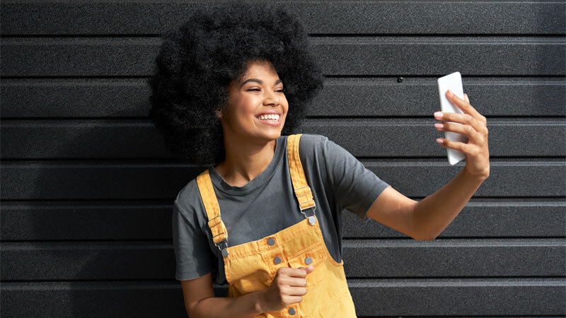 Alphabet Tik Tok Woman Holding Phone Brick Wall