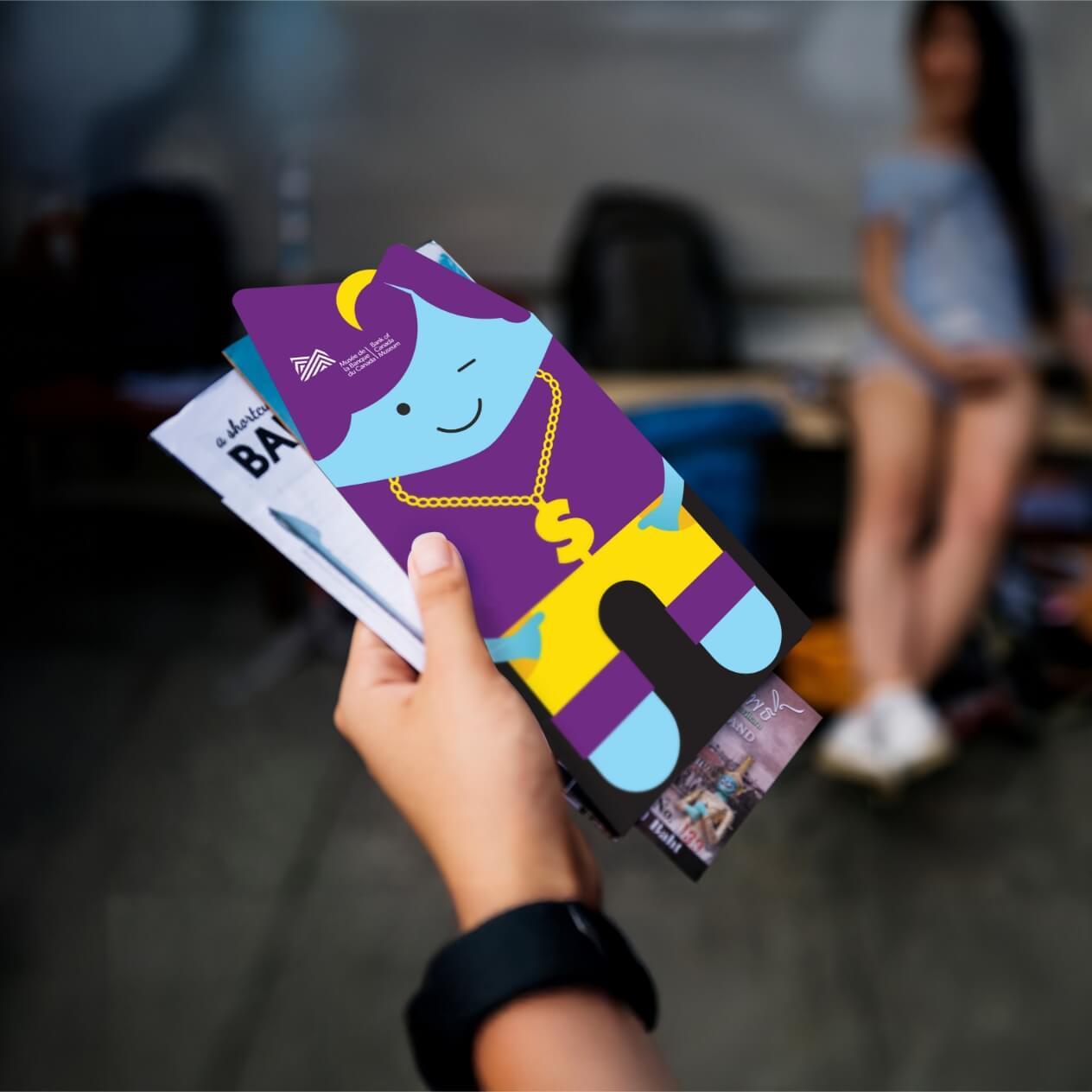 Brochure held in the hand of a museum goer.
